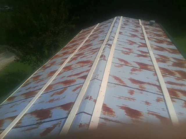 Rusted metal roof panels with new wood purlins before replacement — Storm Damage Roof Repair in Franklin Lakes by Roofing Brothers